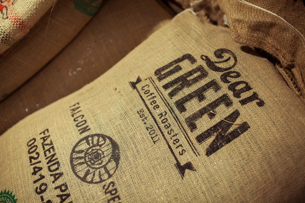 Bag of coffee beans with the Dear Green logo on it. The coffee beans are from Fazenda Pantano in Brazil.